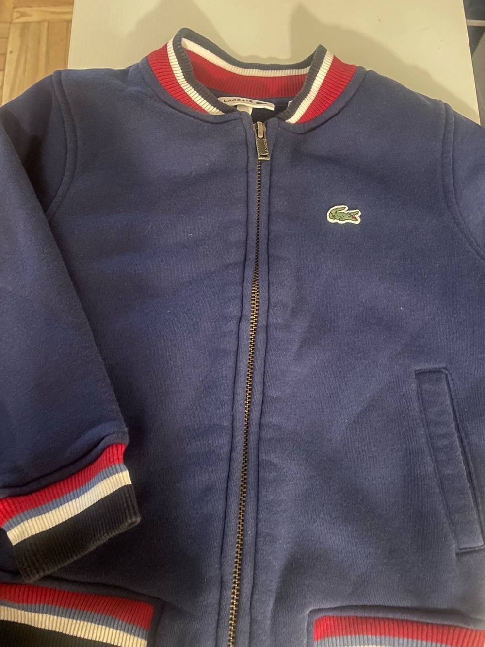 Lacoste Kids Navy Zip Bomber Jacket with Red & White Trim. Size 4